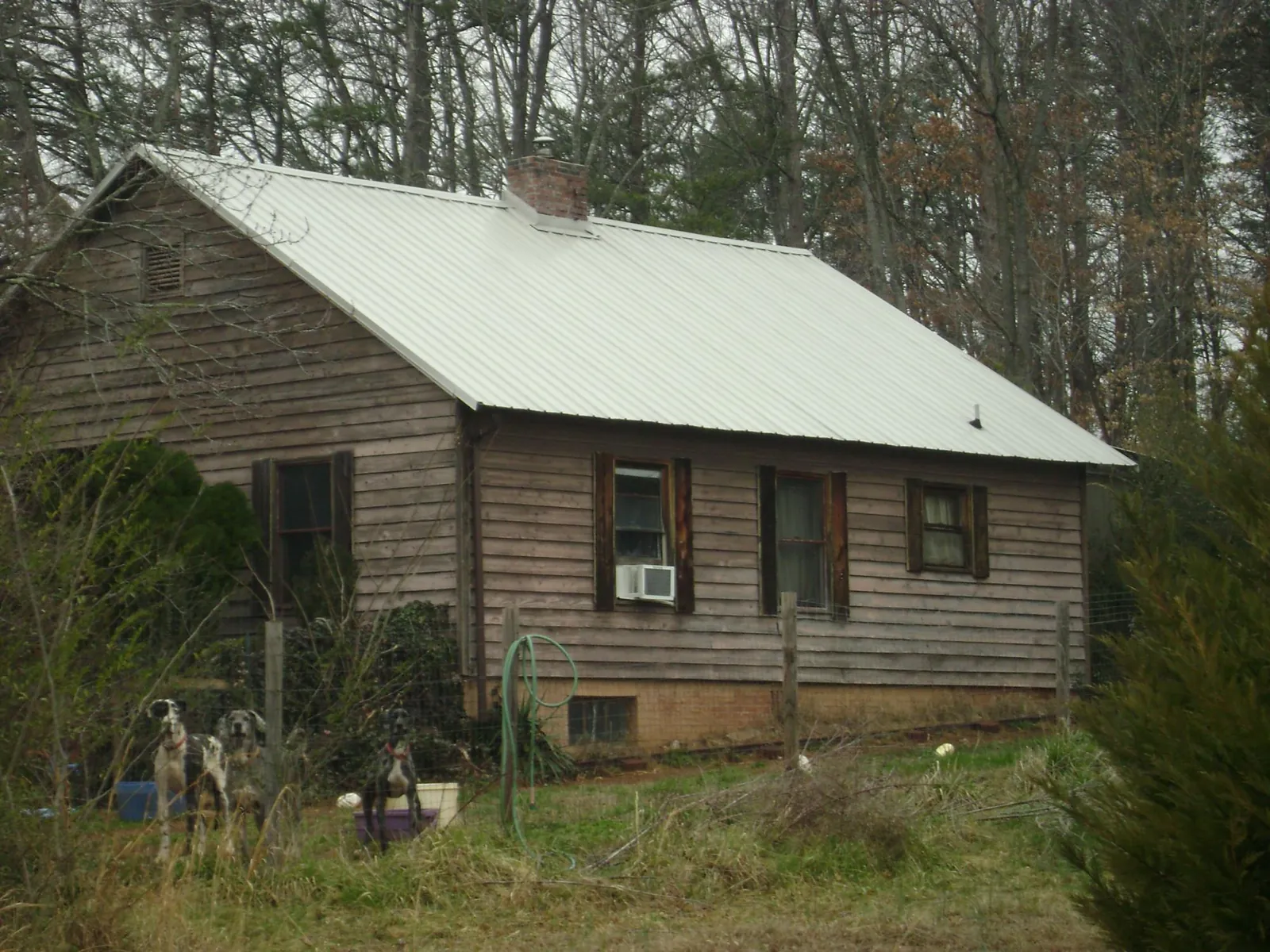 White metal roof on an old wood sided farmhouse, from a Metal Roof Installation job in Myton